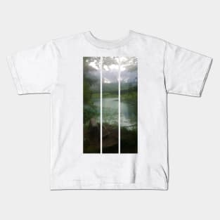 A static shot from the shore of Fusine lake in the Julian Alps with snowy mountains in background and a bench. Beautiful nature in a spring cloudy day; no people around. Italy (vertical) Kids T-Shirt